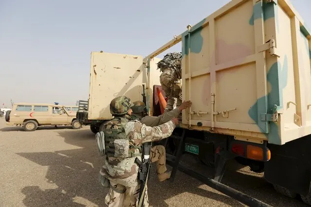 Iraqi security forces climb into trucks travelling to Mosul to fight against militants of Islamic State at an Iraqi army base in Camp Taji in Baghdad, February 21, 2016. (Photo by Ahmed Saad/Reuters)