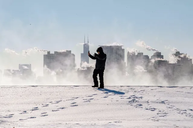 A man takes a selfie video with the Chicago skyline in the background from Montrose Harbor, Chicago, Illinois on January 30, 2019. Chicago's record for the coldest temperature was shattered on Wednesday as the polar vortex struck the biggest city in the U.S. Midwest, according to the National Weather Service. (Photo by Xinhua News Agency/Rex Features/Shutterstock)