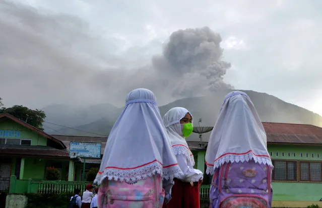 Students are seen at school as Mount Marapi volcano spews volcanic ash as seen from Nagari Batu Palano in Agam, West Sumatra province, Indonesia on December 4, 2023, in this photo taken by Antara Foto. (Photo by Iggoy el Fitra/Antara Foto via Reuters)