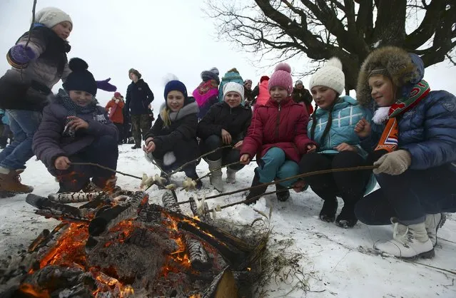 Local residents take part in the celebrations of Kolyada pagan holiday, which over the centuries has merged with Orthodox Christmas festivities and marks the upcoming end of winter, in the village of Martsiyanauka, Belarus, January 21, 2017. (Photo by Vasily Fedosenko/Reuters)