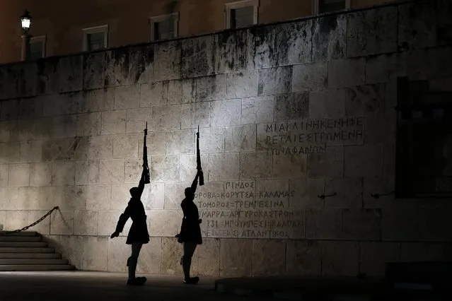 Presidential guards perform during a changing of the guard ceremony, at the tomb of the unknown soldier, in front of the Greek parliament in central Athens, Monday, April 6, 2015. (Photo by Petros Giannakouris/AP Photo)