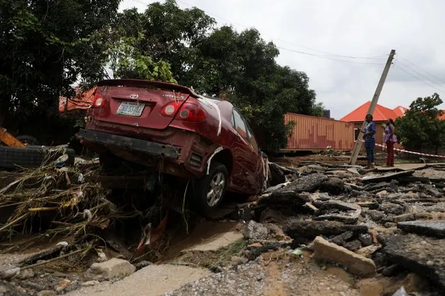 A car washed away during the flooding which destroyed several homes at Trademore estate Abuja, Nigeria on September 13, 2021. (Photo by Afolabi Sotunde/Reuters)