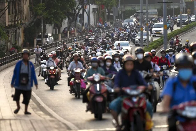 Commuters on scooters fill the street during morning rush hour in Ho Chi Minh City, Vietnam, January 12, 2024. (Photo by Jae C. Hong/AP Photo)