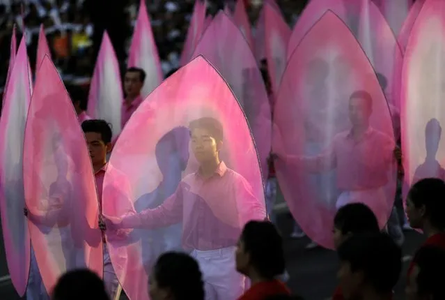 Vietnamese youths perform during a parade celebrating the 40th anniversary of the end of the Vietnam War which is also remembered as the “Fall of Saigon”, in Ho Chi Minh City, Vietnam, Thursday, April 30, 2015. (Photo by Dita Alangkara/AP Photo)