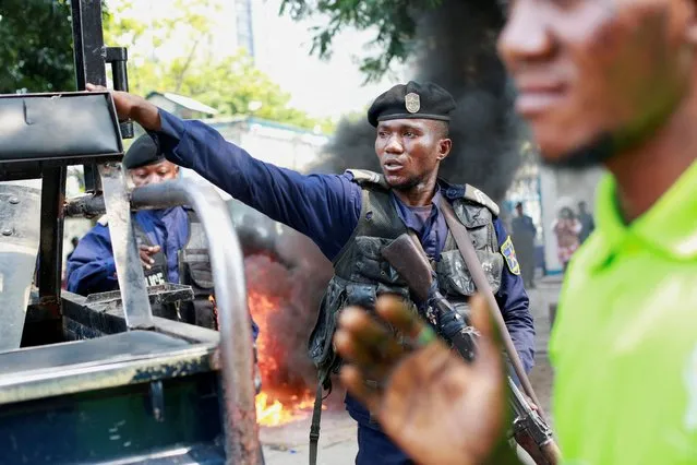 A police officer reacts during a protest near the UN mission in Congo MONUSCO headquarters in downtown Kinshasa, Democratic Republic of Congo on February 12, 2024. (Photo by Justin Makangara/Reuters)