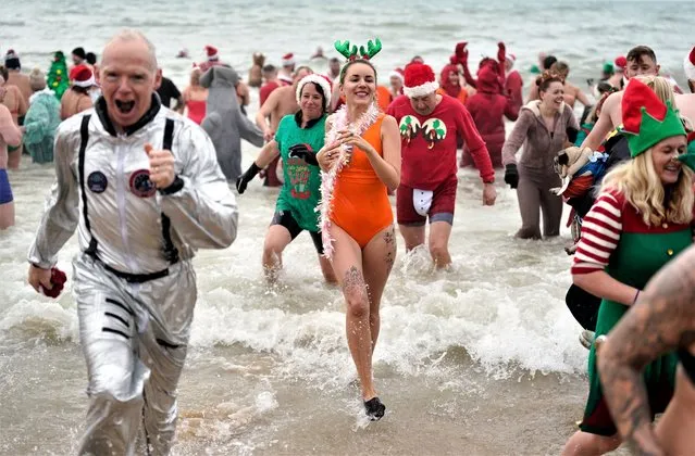 Swimmers take part in the Macmillan Boscombe White Christmas Dip, in aid of Macmillan Caring Locally, at Boscombe Pier, Bournemouth, Dorset on Sunday, December 25, 2022. (Photo by Andrew Matthews/PA Images via Getty Images)