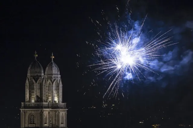 Fireworks illuminate the night sky over Zurich, Switzerland during New Year's Eve celebrations on Saturday, December 31, 2022. (Photo by Michael Buholzer/Keystone via AP Photo)