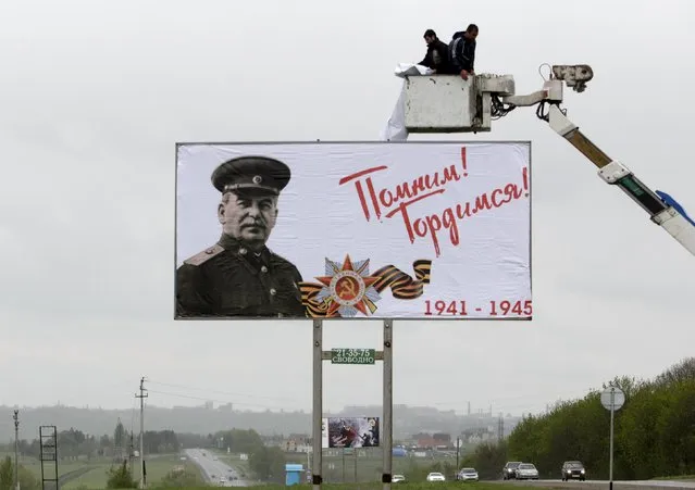 Workers fix a banner showing an image of former Soviet leader Joseph Stalin during preparations for Victory Day outside Stavropol, Russia, May 6, 2015. Russia will celebrate the 70th anniversary of the victory over Nazi Germany in World War Two on May 9. The banner reads “We remember (you)! We are proud (of you)!”. (Photo by Eduard Korniyenko/Reuters)