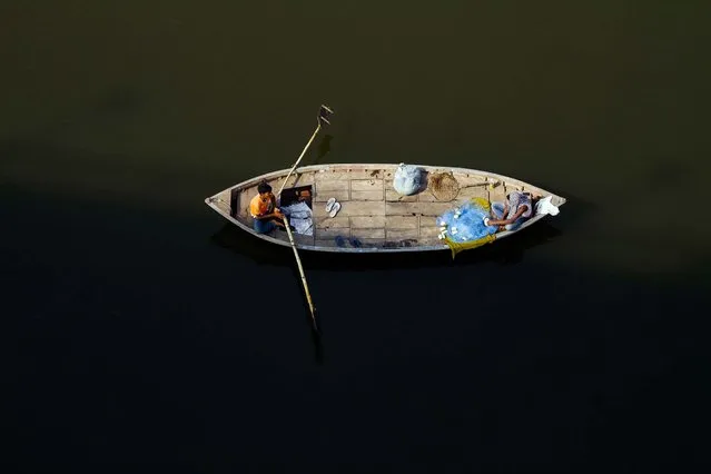 A fisherman rows a boat in the River Ganges in Allahabad, India. (Photo by Rajesh Kumar Singh/Associated Press)