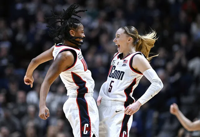 UConn guards KK Arnold, left, and Paige Bueckers, right, celebrate during the first half of an NCAA college basketball game against Georgetown in the finals of the Big East Conference tournament at Mohegan Sun Arena, Monday, March 11, 2024, in Uncasville, Conn. (Photo by Jessica Hill/AP Photo)