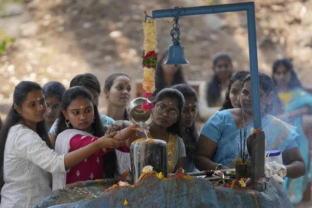 Hindu devotees pour milk on a shivling, a representation of Hindu god Shiva, during Shivratri festival in Hyderabad, India, Friday, March 8, 2024. “Shivratri”, or the night of Shiva, is dedicated to the worship of Lord Shiva, the Hindu god of death and destruction. (Photo by Mahesh Kumar A./AP Photo)