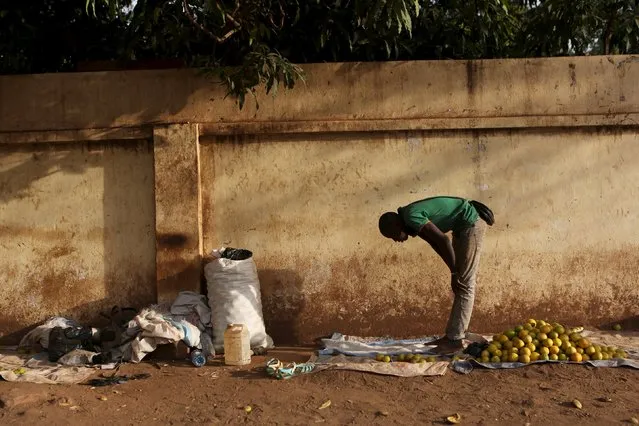 A fruit vendor prays on the side of a street in Bamako, Mali, April 11, 2016. (Photo by Joe Penney/Reuters)