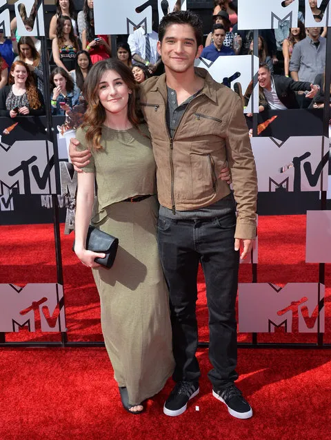 Actor Tyler Posey (R) and Seana Gorlick attend the 2014 MTV Movie Awards at Nokia Theatre L.A. Live on April 13, 2014 in Los Angeles, California. (Photo by Michael Buckner/Getty Images)
