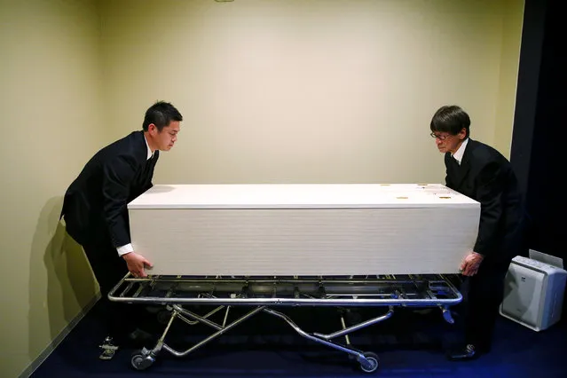 Staff members remove a coffin from a room of the “Corpse Hotel” in Kawasaki, Japan, April 20, 2016. (Photo by Thomas Peter/Reuters)