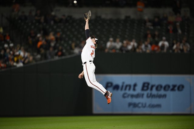 Baltimore Orioles shortstop Gunnar Henderson leaps for but misses a ball that went for a single by Boston Red Sox's Rob Refsnyder during the eighth inning of a baseball game, Wednesday, May 29, 2024, in Baltimore. (Photo by Nick Wass/AP Photo)