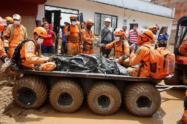 Rescue members recover a body in a house after flooding and mudslides caused by heavy rains leading several rivers to overflow, pushing sediment and rocks into buildings and roads, in Mocoa, Colombia April 3, 2017. (Photo by Jaime Saldarriaga/Reuters)
