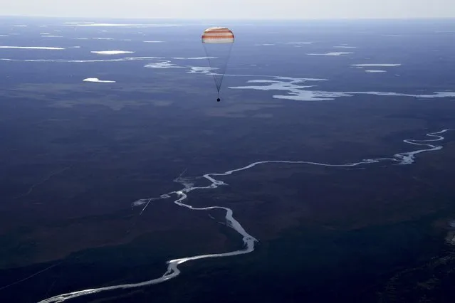 Russia's Soyuz MS-02 space capsule carrying the International Space Station (ISS) crew members, NASA astronaut Shane Kimbrough and cosmonauts Sergey Ryzhikov and Andrey Borisenko of the Russian space agency Roscosmos, descends before landing in a remote area outside the town of Dzhezkazgan (Zhezkazgan), Kazakhstan, April 10, 2017. (Photo by Kirill Kudryavtsev/Reuters)