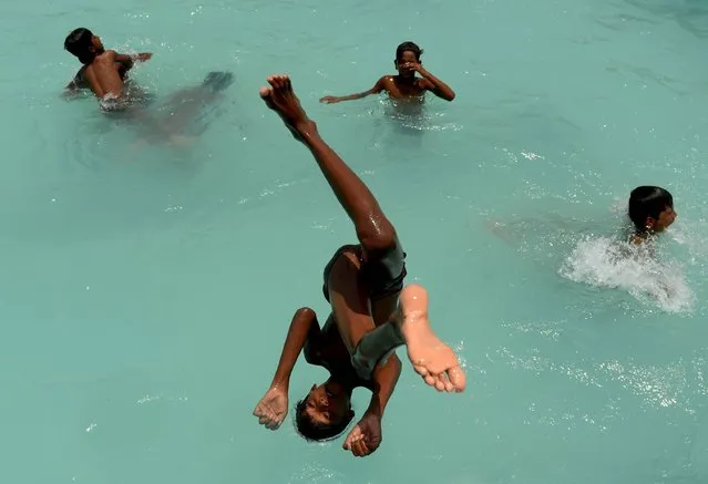 An Indian youth dives into a swimming pool in Chennai on May 10, 2017. (Photo by Arun Sankar/AFP Photo)
