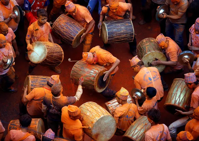 Devotees play traditional musical instruments while celebrating the “Sindoor Jatra” vermillion powder festival at Thimi, in Bhaktapur, Nepal April 15, 2017. (Photo by Navesh Chitrakar/Reuters)