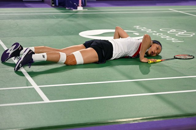 South Korea's An Se-young reacts on the floor in her women's singles badminton quarter-final match against Japan's Akane Yamaguchi during the Paris 2024 Olympic Games at Porte de la Chapelle Arena in Paris on August 3, 2024. (Photo by Arun Sankar/AFP Photo)