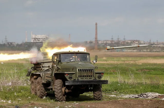 Service members of pro-Russian troops fire a BM-21 Grad multiple rocket launch system during fighting in Ukraine-Russia conflict near a plant of Azovstal Iron and Steel Works in the southern port city of Mariupol, Ukraine on May 2, 2022. (Photo by Alexander Ermochenko/Reuters)