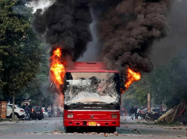 A burning bus is seen after it was set on fire by demonstrators during a protest against a new citizenship law, in New Delhi, India, December 15, 2019. Angry protesters in northeast India vowed on December 15 to keep demonstrating against a contentious citizenship law as the death toll from bloody clashes opposing the bill rose to six. (Photo by Adnan Abidi/Reuters)