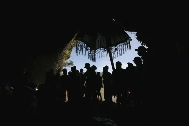 Hindu villagers pray inside a cave during the collection of holy water from a stream for prayers ahead of the annual Kasada festival at Mount Bromo in Indonesia's East Java province, July 31, 2015. (Photo by Reuters/Beawiharta)