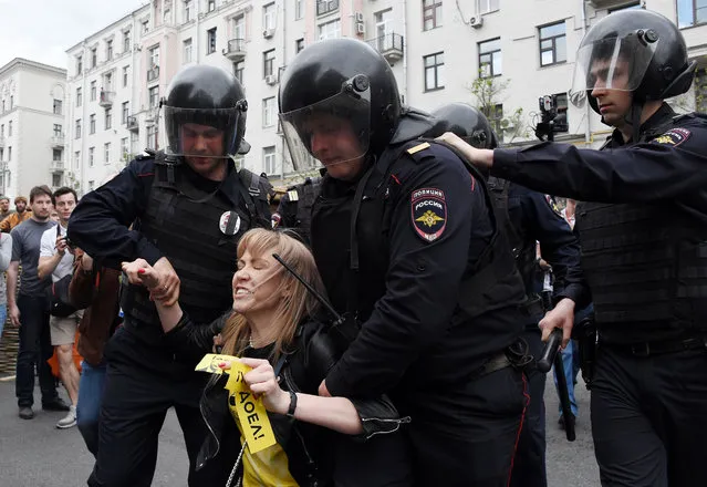 Russian police officers detain Maria Baronova, a coordinator of Khodorkovsky' s Open Russia organization as she participates at the unauthorized opposition rally in Tverskaya street in central Moscow on June 12, 2017. (Photo by Vasily Maximov/AFP Photo)
