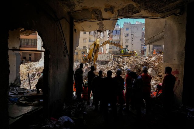 Emergency workers use excavators to clear the rubble at the site of Friday's Israeli strike in Beirut's southern suburbs, Lebanon, Monday, September 23, 2024. (Photo by Hassan Ammar/AP Photo)