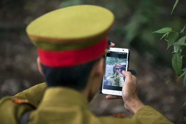 An actor dressed as a Japanese World War Two army officer checks a picture of himself shot with a phone on the set of “The Last Prince” television series on location near Hengdian World Studios near Hengdian July 24, 2015. (Photo by Damir Sagolj/Reuters)