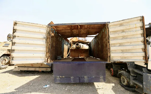 A tank gun hidden inside a truck, made by Islamic State militants, to avoid attack from planes are seen at Federal Police Headquarters after being confiscated in Mosul, Iraq on July 13, 2017. (Photo by Thaier Al-Sudani/Reuters)
