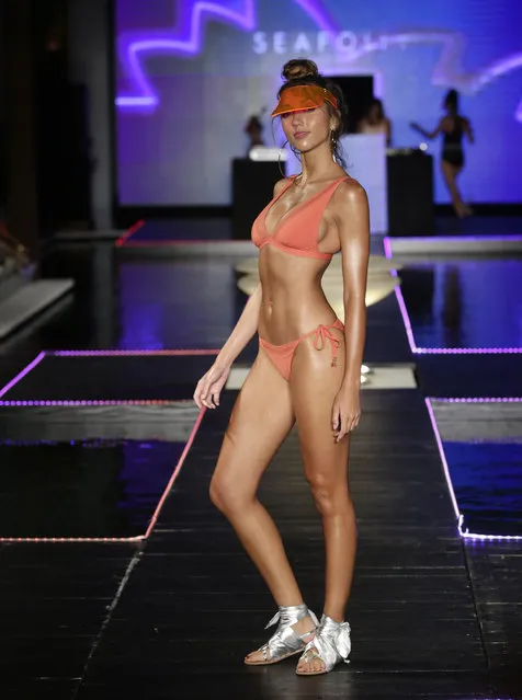 A model walks down the runway wearing Seafolly swimwear at a FUNKSHION fashion show during Swim Week, Sunday, July 23, 2017, in Miami Beach, Fla. (Photo by Lynne Sladky/AP Photo)