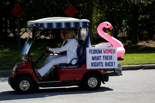 Supporters of Kamala Harris wait in line to drop off their voting ballot during at the Sumter County Supervisor of Elections Office during a golf cart rally in the retirement community of The Villages, Florida, on October, 14, 2024. (Photo by Octavio Jones/Reuters)