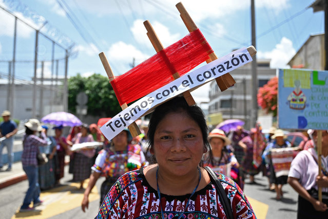 An Indigenous Mayan weaver marches to demand the resignation of Attorney General Consuelo Porras, anti-corruption prosecutor Rafael Curruchiche, and other judicial officials accused of generating an electoral crisis ahead of the runoff vote, outside the Public Ministry in Guatemala City on August 10, 2023. Dozens of indigenous Mayan weavers demanded Thursday the resignation of the Guatemalan prosecutor in a peculiar protest accusing her of “weaving corruption”, after judicial actions that have put in anxiety the presidential runoff of August 20. (Photo by Johan Ordóñez/AFP Photo)