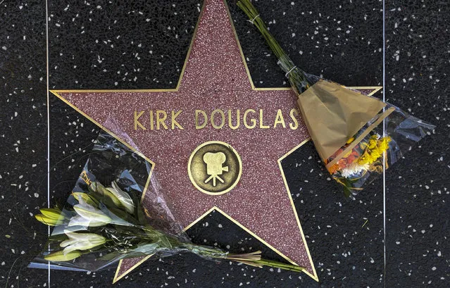 Flowers are placed on actor Kirk Douglas' star on the Hollywood Walk of Fame in Los Angeles, Wednesday, February 5, 2020. Douglas, the muscular actor with the dimpled chin who starred in “Spartacus”, “Lust for Life” and dozens of other films and helped fatally weaken the Hollywood blacklist, has died at 103. (Photo by Damian Dovarganes/AP Photo)