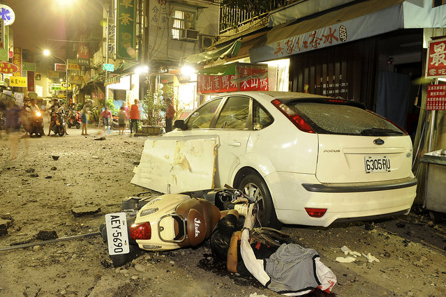 A person is seen lying on the ground after an explosion in Kaohsiung, southern Taiwan, August 1, 2014. An explosion caused by a gas leak in the southern Taiwanese city Kaohsiung has killed 15 people and injured another 243, Taiwanese media reported on Friday. (Photo by Reuters/Stringer)