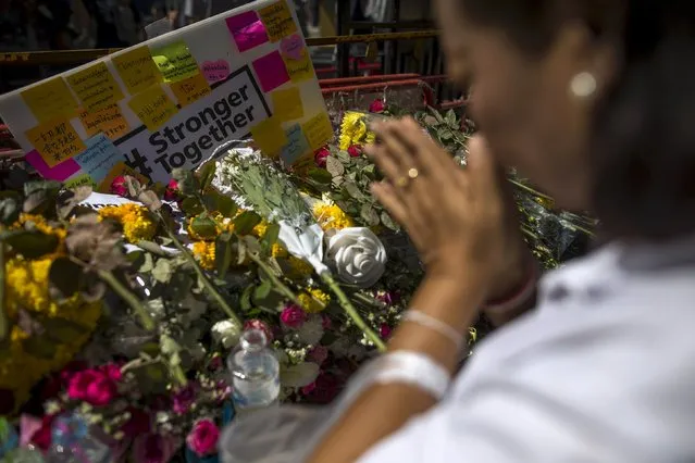 A woman pays her respects at the Erawan shrine, the site of Monday's deadly blast, in central Bangkok, Thailand, August 19, 2015. (Photo by Athit Perawongmetha/Reuters)