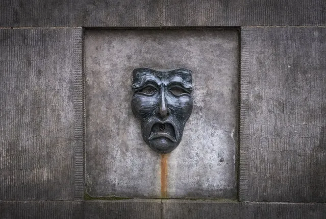 A bronze theatre mask on Edinburgh's Royal Mile, in Edinburgh, Scotland,  Wednesday April 1, 2020. Every August, the Scottish capital of Edinburgh plays host to some of the funniest and talented – not to forget the strangest – artists from the U.K. and the wider world. Not this year, as organizers made the decision Wednesday to cancel the city's festivals as a result of the coronavirus pandemic. (Photo by Jane Barlow/PA Wire via AP Photo)
