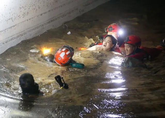 Firefighters and military officials rescue one of the missing residents from the underground parking lot of an apartment building in Nam-gu, Pohang-si, Gyeongsangbuk-do, which was submerged in heavy rain caused by Typhoon Hinnamno in Pohang, South Korea, 07 September 2022. According to fire authorities, two people were rescued alive and three bodies found out of seven people who were reportedly missing in the incident. (Photo by Kim Hee-Chul/EPA/EFE)