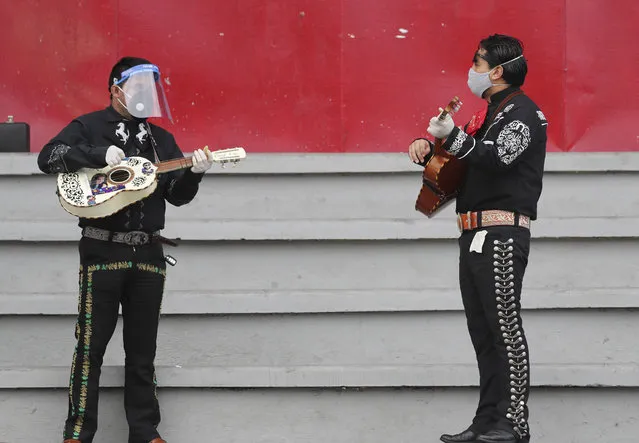 Musicians from Mariachi groups perform during an event to appeal that authorities allow them to work this upcoming Mother's Day in Quito, Ecuador, Tuesday, May 5, 2020. Mariachis have not been able to perform and earn a living since the government ordered in mid-March a national lockdown that includes restrictions on traffic and pedestrian movement to curb the spread of the new coronavirus. (Photo by Dolores Ochoa/AP Photo)