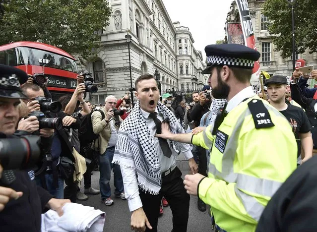 A demonstrator argues with police during a protest outside Downing Street in London, Britain September 9, 2015. (Photo by Toby Melville/Reuters)