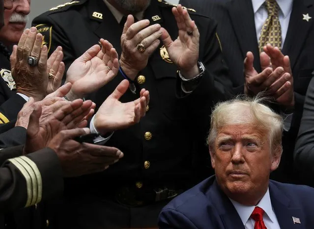 U.S. President Donald Trump listens to applause after signing an executive order on police reform during a ceremony in the Rose Garden at the White House in Washington, U.S., June 16, 2020. (Photo by Leah Millis/Reuters)
