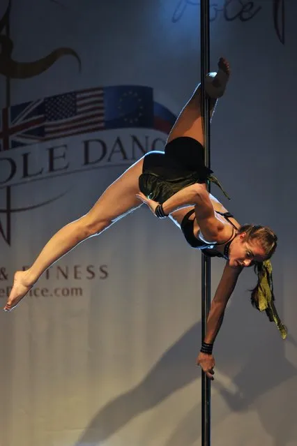 A competitor participates at the World Pole Dancing Championship 2012 held at the Volkshaus on November 10, 2012 in Zurich, Switzerland. The public's perception of pole dancing has recently changed to become a popular sport combining physical strength, technique and choreography.  (Photo by Harold Cunningham)