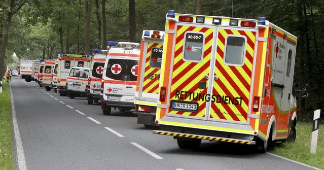 In this September 4, 2015 file photo ambulances stand at a road in Handeloh, Germany. A German psychotherapist has been sentenced to probation after to confessing to providing a group of alternative practitioners psychedelic drugs as part of a seminar on expanding consciousness as a form of therapy Wednesday, November 22, 2017. The 2015 seminar resulted in the hospitalization of the 27 participants with cramps, delirium and other complications from ingesting the psychadelic drug 2C-E and also the extremely potent hallucinogen known as DragonFLY in the northwestern town of Handeloh. (Photo by Christian Butt/DPA via AP Photo)