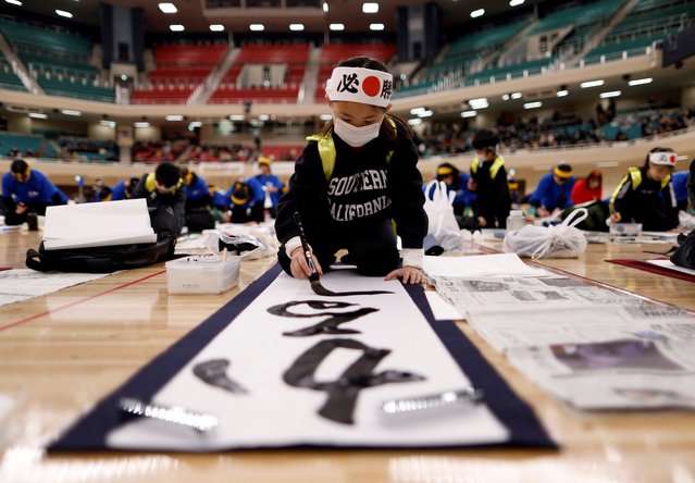 A girl participates in a New Year calligraphy contest at Nippon Budokan in Tokyo, Japan on January 5, 2024. (Photo by Issei Kato/Reuters)