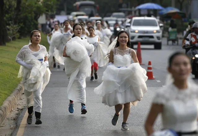Thai brides-to-be compete in the “Running of the Brides” event in Bangkok, Thailand, 02 December 2017. (Photo by Rungroj Yongrit/EPA/EFE/Rex Features/Shutterstock)