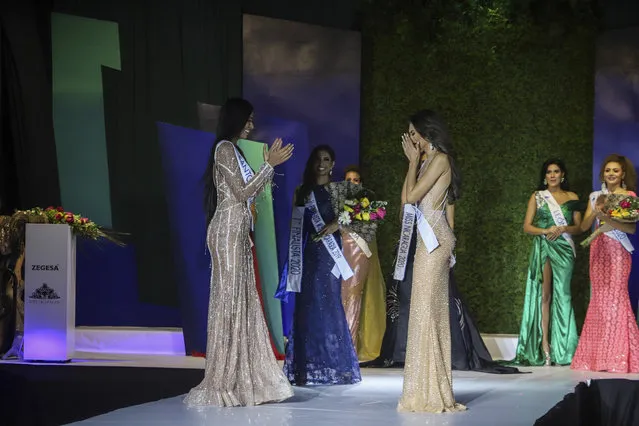 Ana Marcelo, an agroindustrial engineer from the city of Esteli, center right, reacts after being chosen Miss Nicaragua, in Managua, Nicaragua, Saturday, August 8, 2020. Marcelo was crowned in front of a limited audience (two people per contestant spaced safely) plus a production crew of 85. The masks were off the contestants, but the judges wore them and were spaced at a safe distance. (Photo by Alfredo Zuniga/AP Photo)