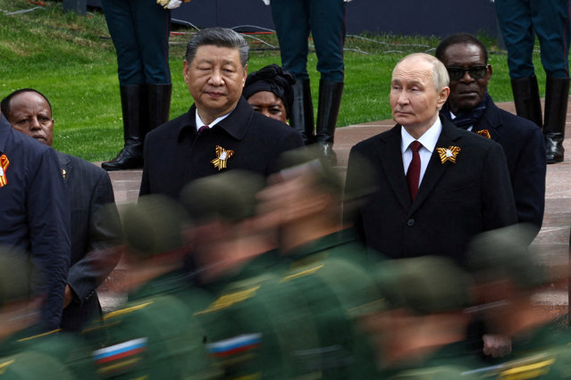Russian President Vladimir Putin and Chinese President Xi Jinping watch Russian service members marching past during a flower-laying ceremony at the Tomb of the Unknown Soldier on Victory Day, marking the 80th anniversary of the victory over Nazi Germany in World War Two, in central Moscow, Russia, on May 9, 2025. (Photo by Evgenia Novozhenina/Reuters)