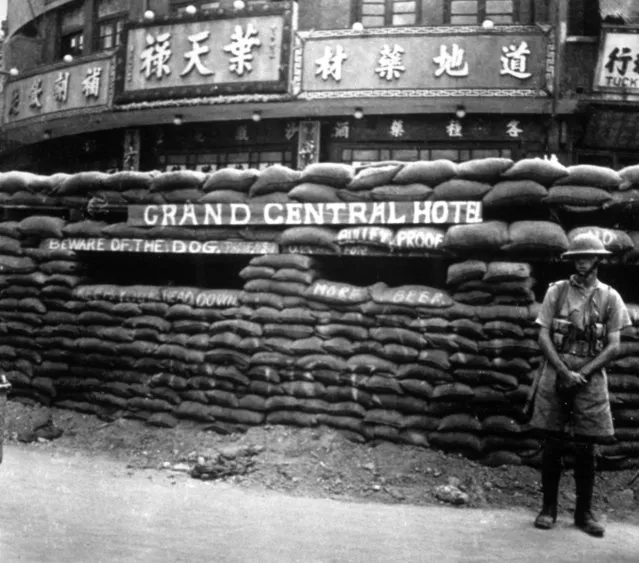 A British soldier standing near the North Station, Chapei (Chinese territory Shanghai) during the Sino-Japanese conflict, circa 1935. They named their dugouts and sandbag emplacements in a style reminiscent of the 1914-1918 war in France. (Photo by Hulton Archive/Getty Images)