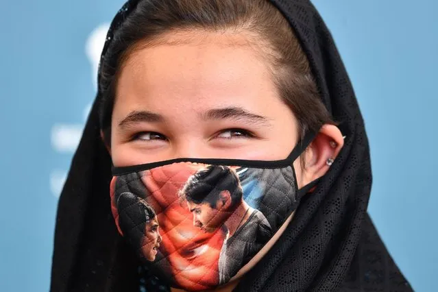 Iranian actress Shamila Shirzad wears a face mask during a photocall for the film “Khorshid” (Sun Children) presented in competition on the fifth day of the 77th Venice Film Festival, on September 6, 2020 at Venice Lido, during the COVID-19 infection, caused by the novel coronavirus. (Photo by Tiziana Fabi/AFP Photo)